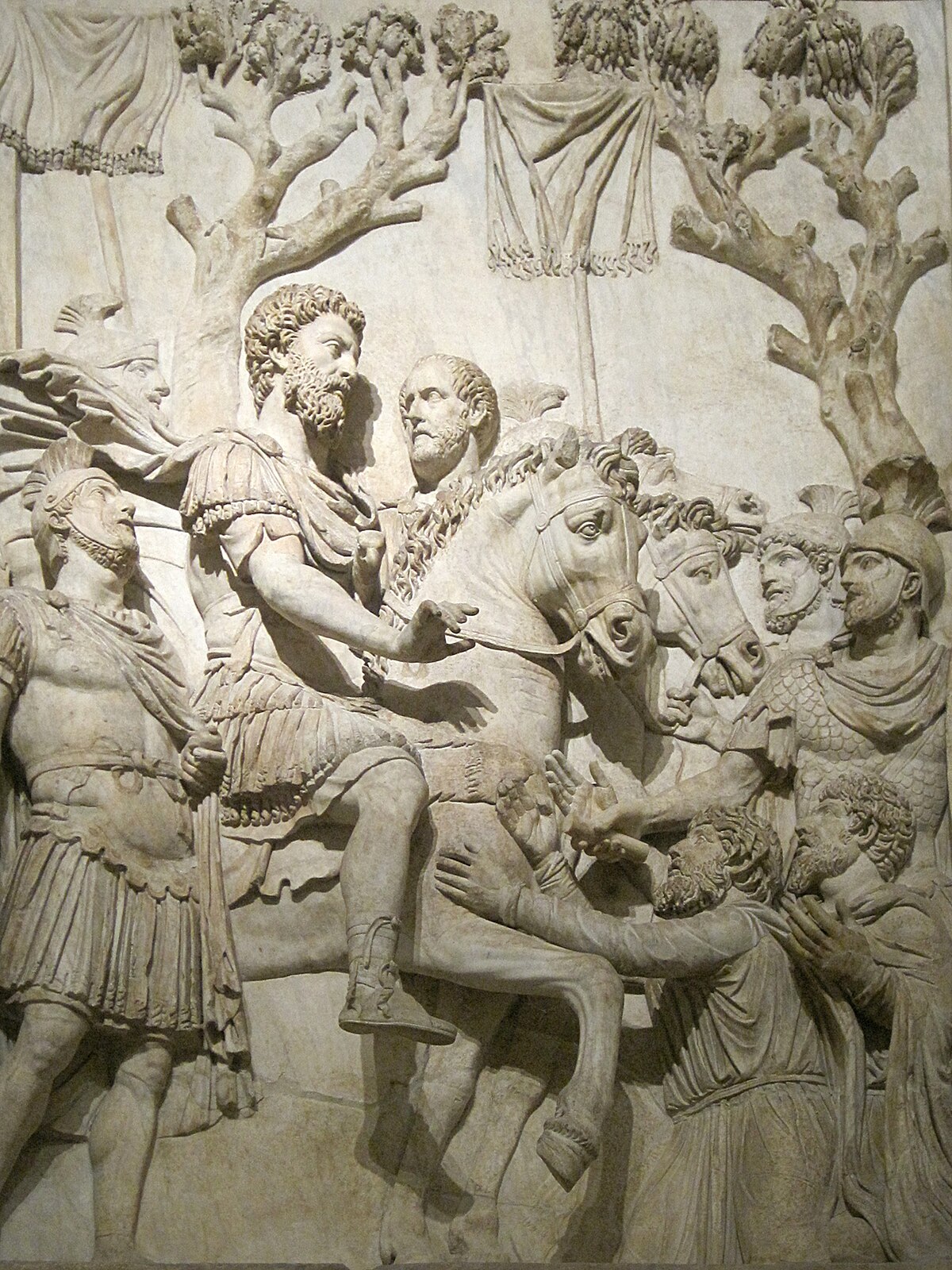Roman marble relief from an honorary monument to Marcus Aurelius, depicting the submission of Germanic tribes. Marcus Aurelius is shown on horseback, surrounded by Roman soldiers, with kneeling Germanic figures before him.