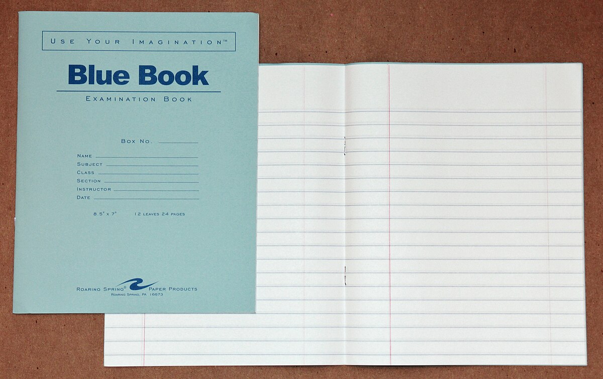 A light blue "Blue Book Examination Book" is shown next to an open, lined examination booklet. The cover includes fields for "Box No.", "Name", "Subject", "Class", "Section", "Instructor", and "Date", and states "USE YOUR IMAGINATION" and "8-1/2" x 11" 12 PAGES 24 RULES."
