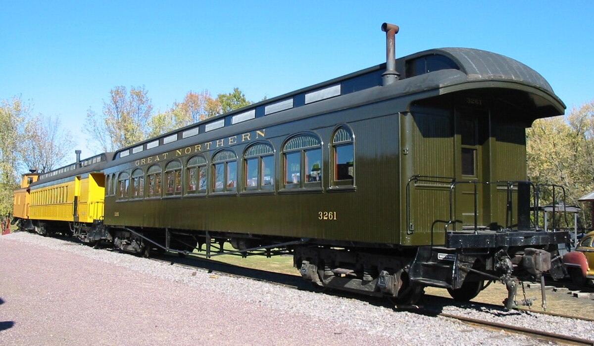 A Barney and Smith Car Company clerestory-roofed passenger car, GN 3261, at the Mid-Continent Railway Museum. The dark green train car features a distinctive raised clerestory roof that ends in a bullnose design.