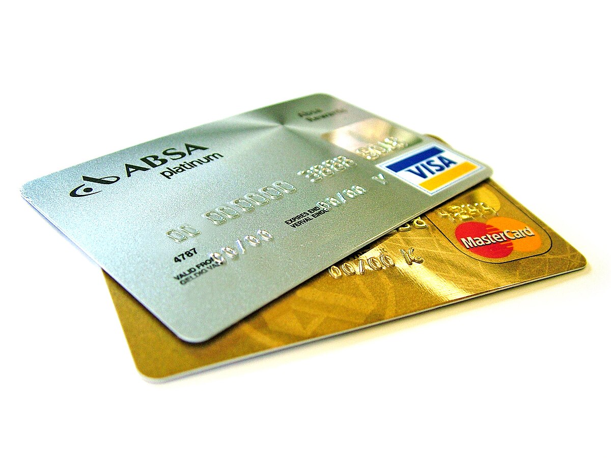 Two credit cards, an ABSA Platinum Visa card and a Mastercard, are stacked on a white background. The ABSA card is silver with a Visa logo, and the Mastercard is gold, both displaying typical credit card features like embossed numbers and magnetic strips.