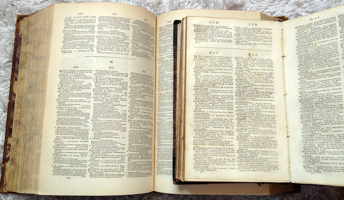 Samuel Johnson's Folio and Abridged Dictionaries are displayed open side-by-side, revealing pages of text with multiple columns and definitions. The larger folio edition is on the left, and the smaller abridged version is on the right.