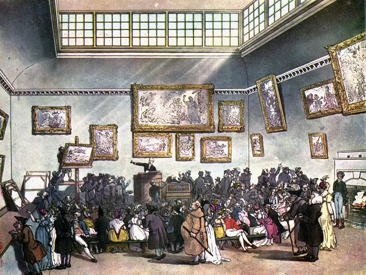 Illustration of an auction room at Christie's, from "Microcosm of London Plate 006". A large crowd of people is gathered, seated and standing, while an auctioneer stands at a podium in the center, gesturing towards a painting on display. Numerous paintings adorn the walls of the grand hall.