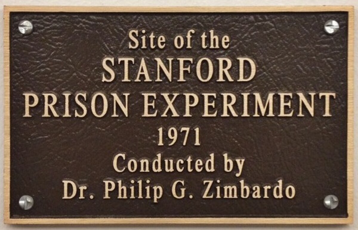 A bronze plaque marking the site of the Stanford Prison Experiment, which reads "Site of the STANFORD PRISON EXPERIMENT 1971 Conducted by Dr. Philip G. Zimbardo."