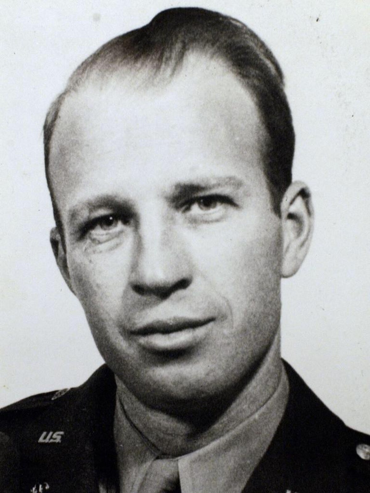 Portrait of Frank Olson in 1953, showing him in military uniform. He has short, light-colored hair and is looking directly at the camera.