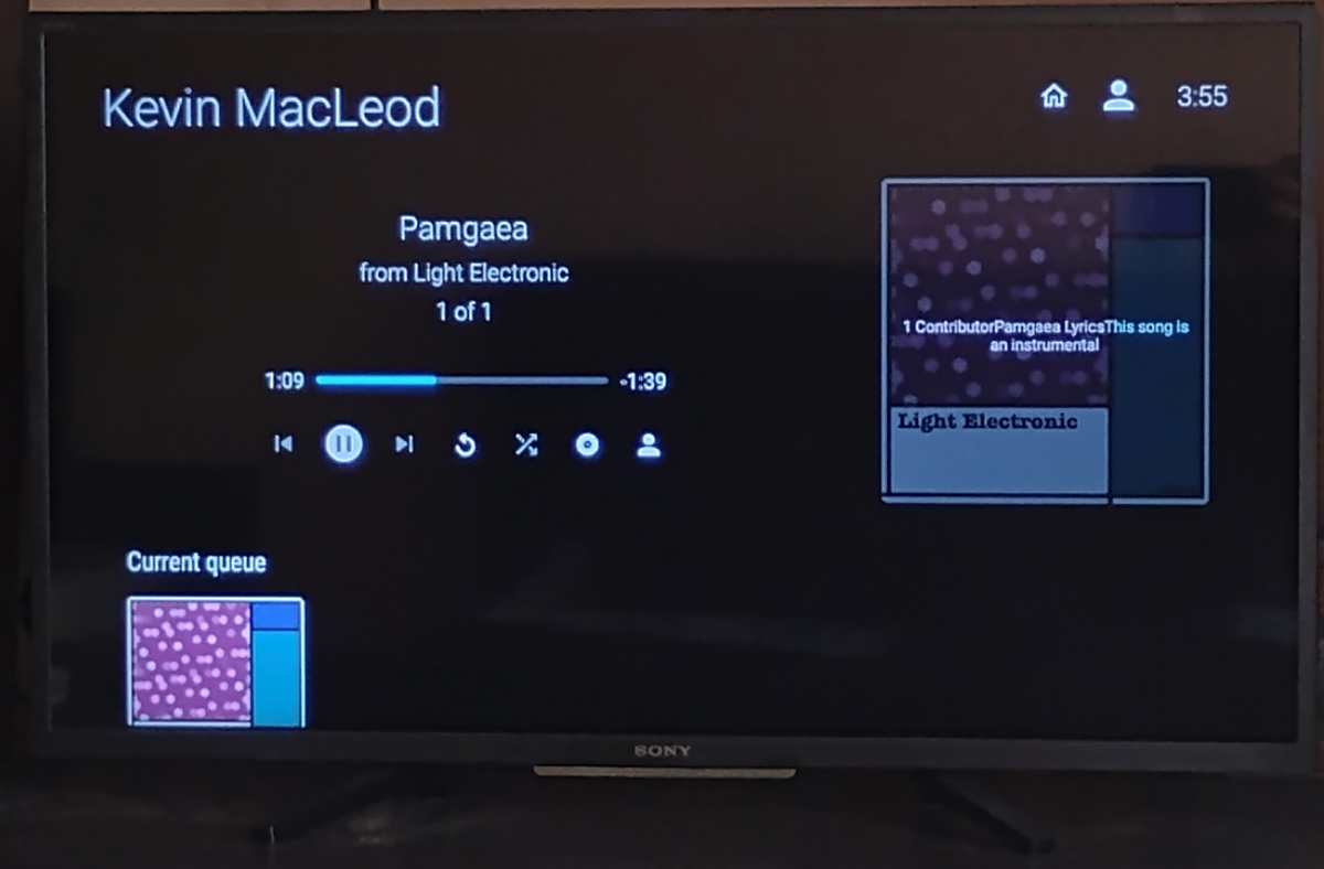 A TV screen displays the Jellyfin interface, streaming an audio file titled "Pamgaea" by Kevin MacLeod from "Light Electronic". The screen shows playback controls, a progress bar at 1:09 of 1:39, and a current queue with album art.