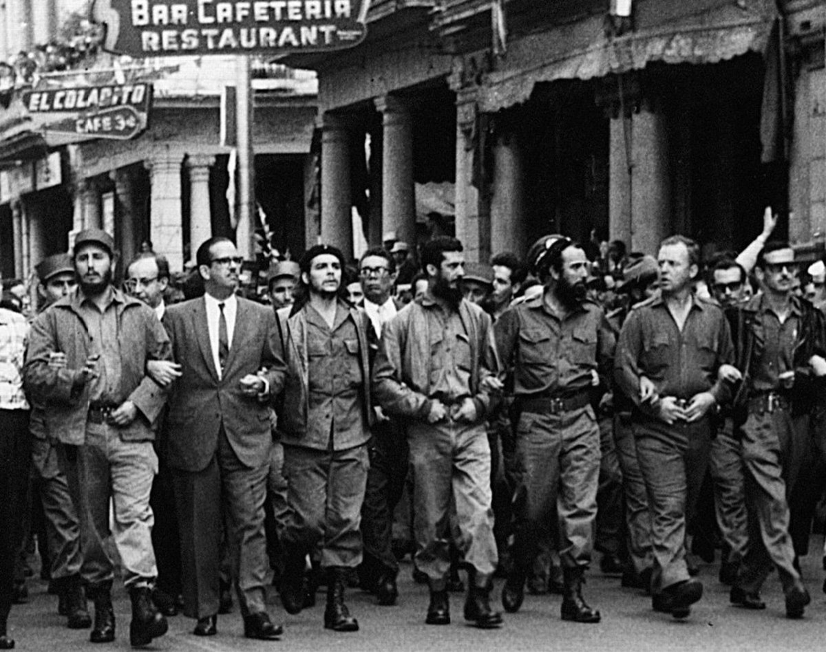 A group of men, including Fidel Castro and Che Guevara, march in a memorial service for victims of the La Coubre explosion on March 5, 1960, in Havana. From left to right, the individuals are Fidel Castro, Osvaldo Dorticós Torrado, Che Guevara, Augusto Martínez Sánchez, Antonio Núñez Jiménez, William Alexander Morgan, and Eloy Gutiérrez Menoyo.