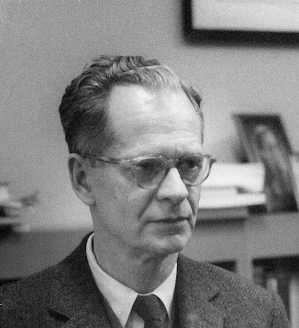 Portrait of B.F. Skinner at the Harvard Psychology Department circa 1950, showing him wearing glasses and a suit jacket, looking slightly to the right.