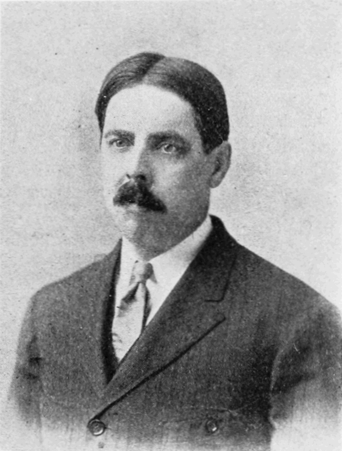 Portrait of Edward Lee Thorndike in 1912, a man with dark hair, a mustache, and wearing a suit and tie, looking directly at the viewer.