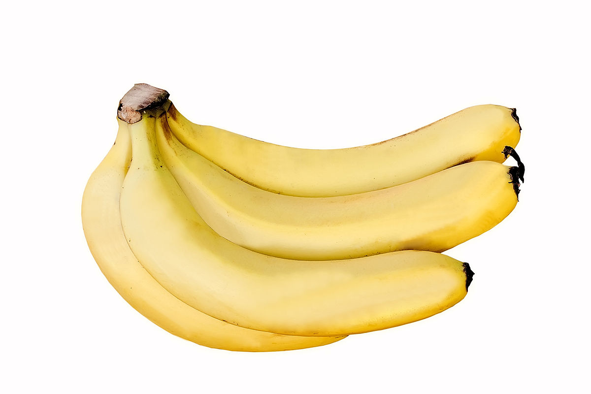 A bunch of ripe Cavendish bananas, yellow in color, is displayed against a white background. The bananas are still attached to their stem.