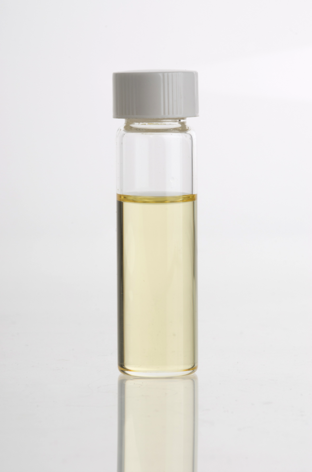 A clear glass vial containing light yellow clove essential oil, with a white screw cap, set against a plain white background.